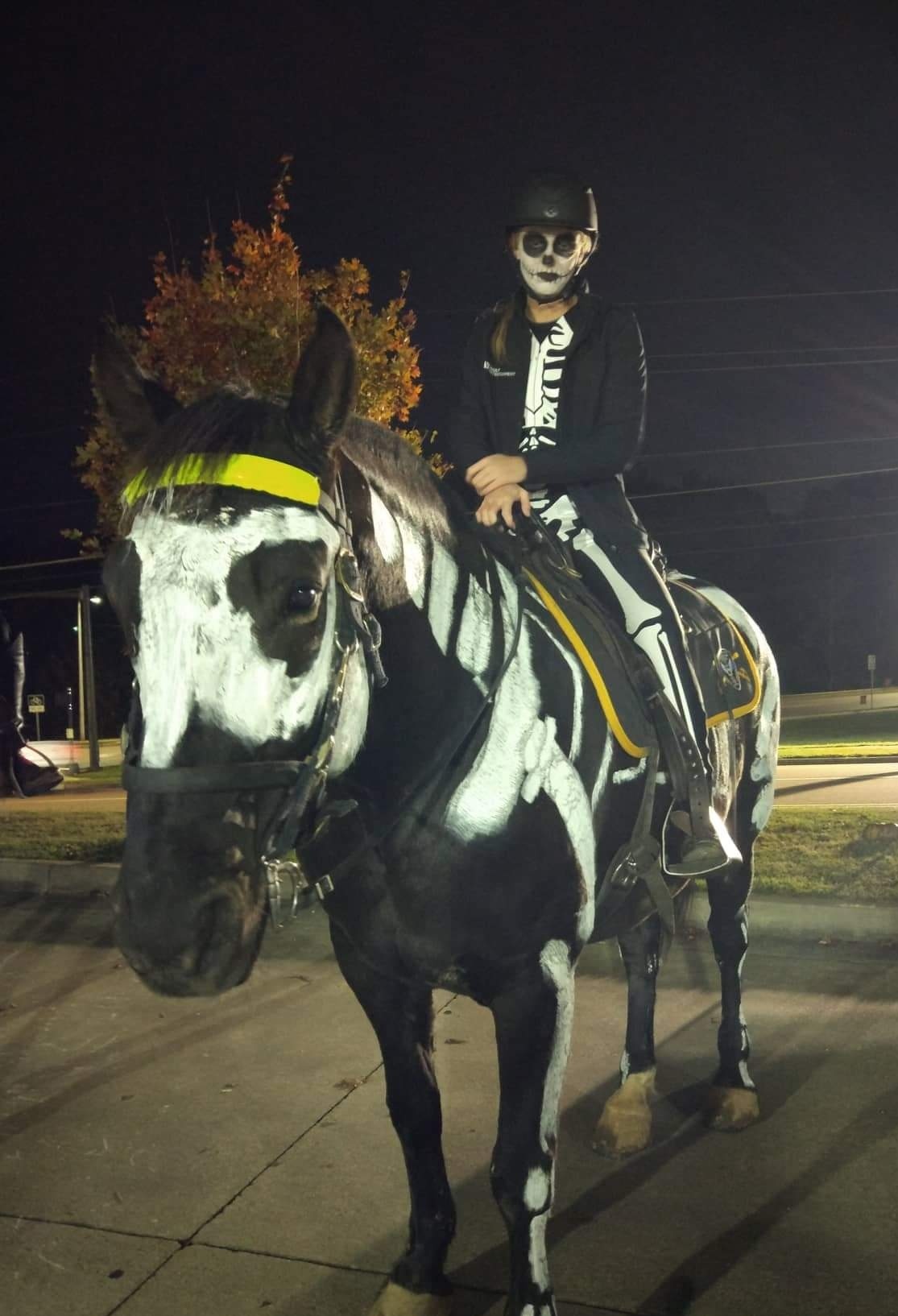 Police horses and riders painted as skeletons.