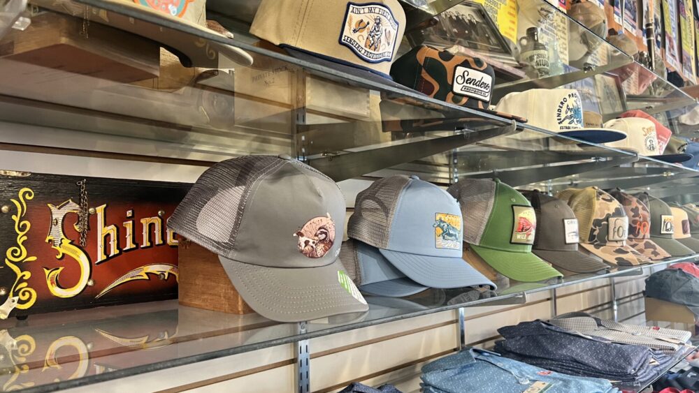 Hats and shirts on shelves.