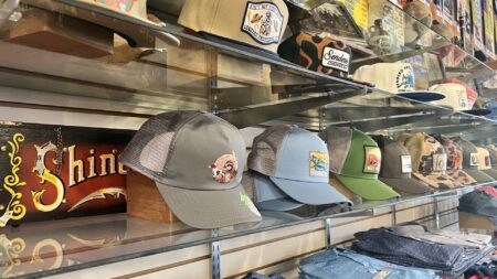 Hats and shirts on shelves.