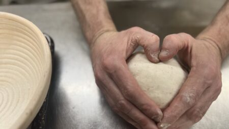 Hands molding dough.