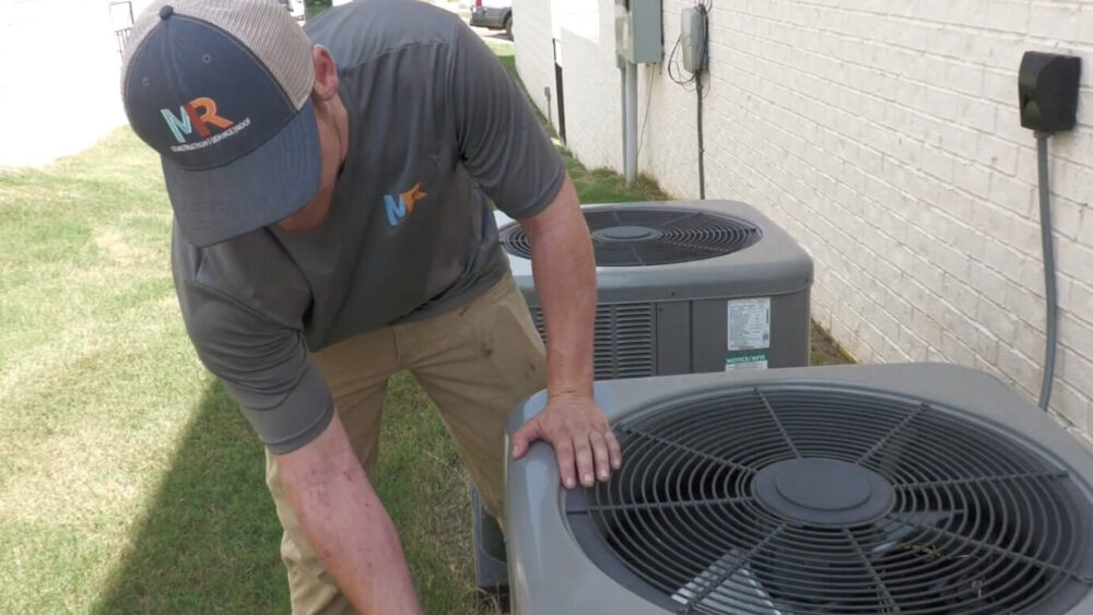 HVAC technician with AC unit