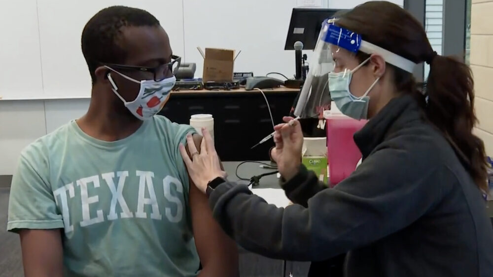 Young person getting a shot.