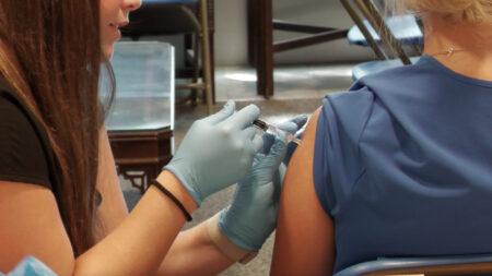 Flu vaccine being administered.