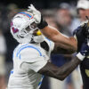 Wake Forest running back Tate Carney stiff arms Ole Miss cornerback Trey Amos