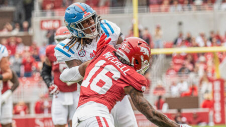 Ole Miss Rebels tight end Dae'Quan Wright takes a hit from Arkansas Razorbacks defensive back Miguel Mitchell