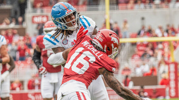 Ole Miss Rebels tight end Dae'Quan Wright takes a hit from Arkansas Razorbacks defensive back Miguel Mitchell