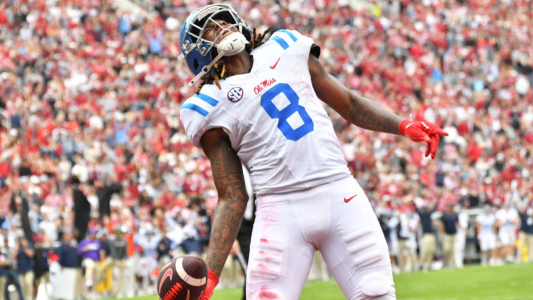 Ole Miss tight end Dae'Quan Wright celebrates and throws the ball in the air after scoring in the first half against Arkansas