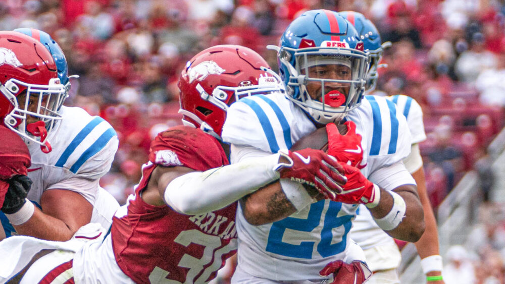 Ole Miss Rebels running back Domonique Thomas tries to avoid a tackle by Arkansas Razorbacks Larry Worth