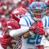 Ole Miss Rebels running back Domonique Thomas tries to avoid a tackle by Arkansas Razorbacks Larry Worth