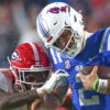 Ole Miss Rebels quarterback Jaxson Dart runs the ball as Georgia defensive back KJ Bolden