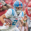 Rebels quarterback Jaxson Dart runs through Arkansas defenders Larry Worth and Landon Jackson