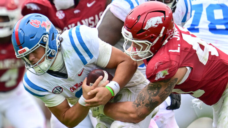 Razorbacks defensive lineman Landon Jackson brings down Ole Miss quarterback Jaxson Dart