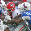 Georgia running back Trevor Etienne runs the ball as Ole Miss linebacker TJ Dottery (6) makes the tackle