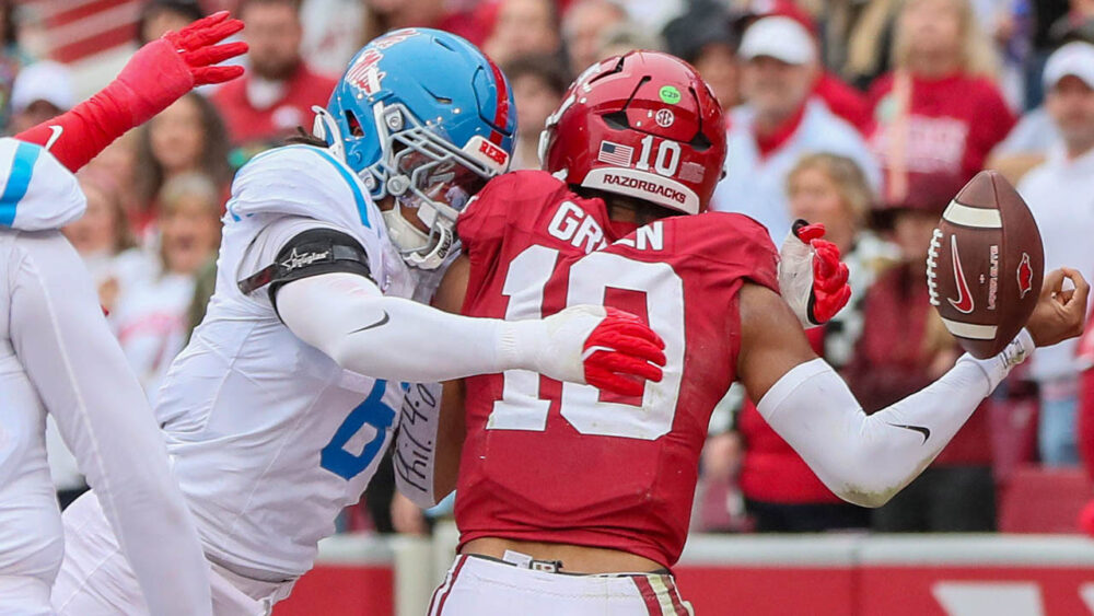 Razorbacks quarterback Taylen Green fumbles as he is hit by Ole Miss linebacker TJ Dottery