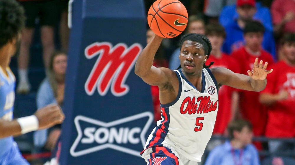 Ole Miss Rebels guard Jaylen Murray passes the ball as he jumps over Long Island Sharks guard Brent Davis