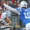 Georgia quarterback Carson Beck drops back to pass as Ole Miss defensive Jared Ivey