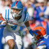 Ole Miss Rebels wide receiver Micah Davis (4) breaks a tackle from Florida Gators defensive back Sharif Denson (0)