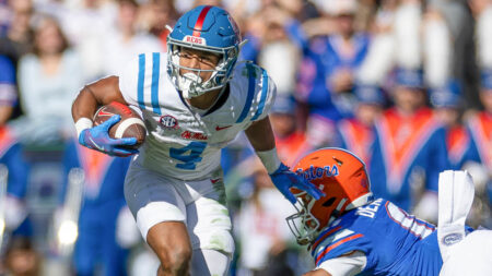 Ole Miss Rebels wide receiver Micah Davis (4) breaks a tackle from Florida Gators defensive back Sharif Denson (0)