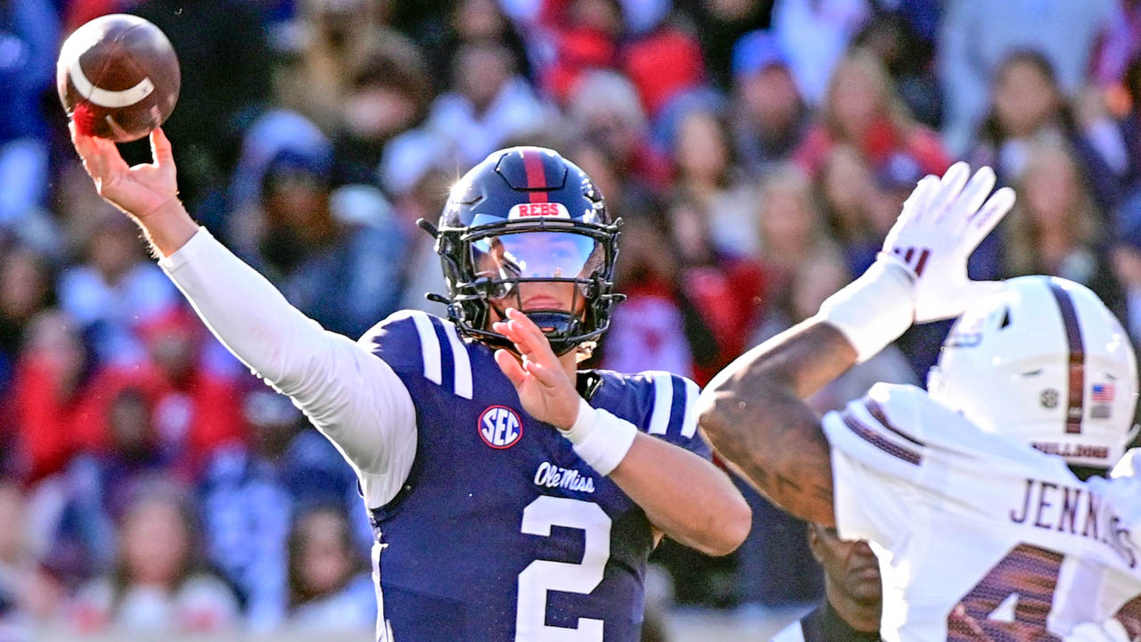 Rebels quarterback Jaxson Dart (2) looks to pass while defended by Mississippi State linebacker Branden Jennings (44)