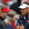 Georgia coach Kirby Smart and Ole Miss coach Lane Kiffin talk prior to the game