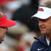 Georgia coach Kirby Smart and Ole Miss coach Lane Kiffin talk prior to the game