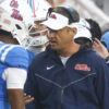 Ole Miss coach Lane Kiffin talks with quarterback Austin Simmons (13) after a touchdown during the first half against Georgia