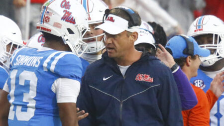 Ole Miss coach Lane Kiffin talks with quarterback Austin Simmons (13) after a touchdown during the first half against Georgia