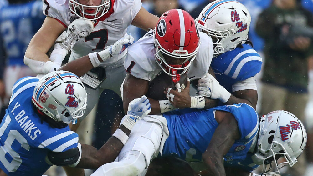 Georgia running back Trevor Etienne (1) runs the ball as Ole Miss defensive back Trey Amos makes the tackle