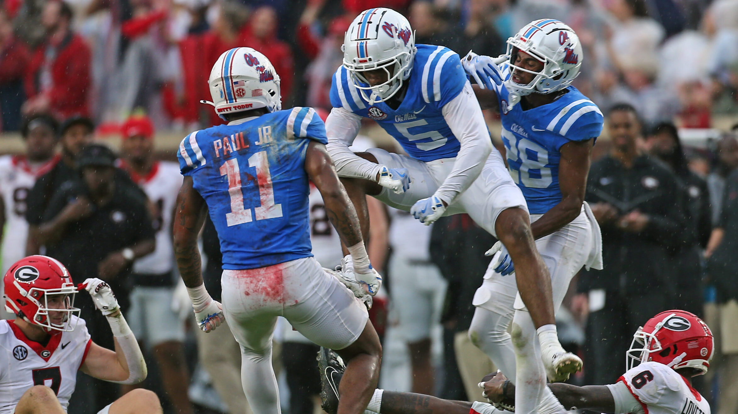 Ole Miss defensive back John Saunders Jr. (5) reacts with linebacker Chris Paul Jr. (11) after a defensive stop during the first half against Georgia