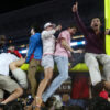 Ole Miss fans attempt to tear down the goal post after defeating Georgia