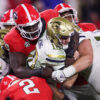 Georgia Tech Yellow Jackets quarterback Haynes King (10) is tackled by Georgia Bulldogs defensive lineman Nazir Stackhouse (78) and linebacker Smael Mondon Jr. (2)