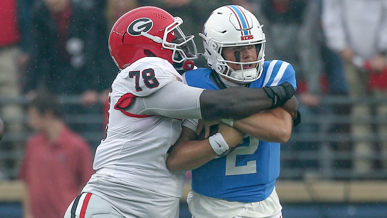 Georgia Bulldogs defensive lineman Nazir Stackhouse tackles Ole Miss Rebels quarterback Jaxson Dart